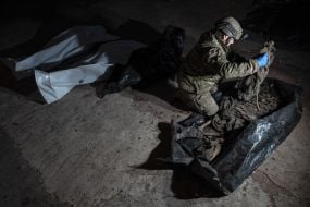 Volunteers of the search organization "Platsdarm" examine the remains of Ukrainian and Russian soldiers in the Donetsk region