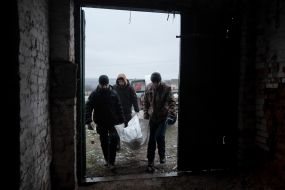 Volunteers of the search organization "Platsdarm" examine the remains of Ukrainian and Russian soldiers in the Donetsk region