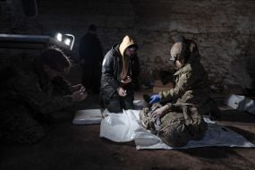 Volunteers of the search organization "Platsdarm" examine the remains of Ukrainian and Russian soldiers in the Donetsk region
