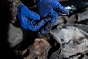 A volunteer of the search organization "Platsdarm" in Donetsk region holds a cross in his hands