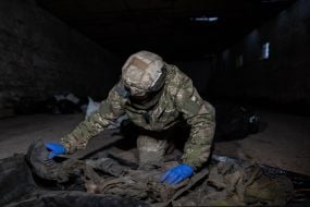 Volunteers of the search organization "Platsdarm" examine the remains of Ukrainian and Russian soldiers in the Donetsk region