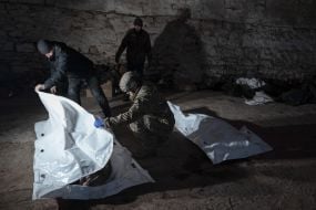 Volunteers of the search organization "Platsdarm" examine the remains of Ukrainian and Russian soldiers in the Donetsk region