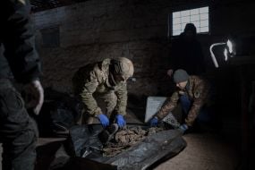 Volunteers of the search organization "Platsdarm" examine the remains of Ukrainian and Russian soldiers in the Donetsk region