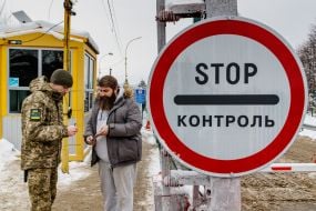 Border guard checks passport