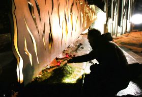 A man lays flowers at the monument to the Heroes of the Heavenly Hundred