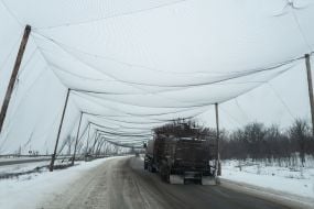 Anti-drone nets are stretched over the road at the entrance to the city of Druzhkivka in Donetsk region