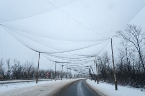Anti-drone nets are stretched over the road at the entrance to the city of Druzhkivka in Donetsk region