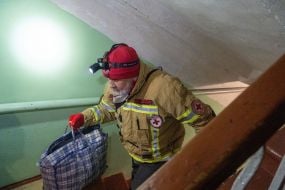 A rescuer removes things from a boarding school building