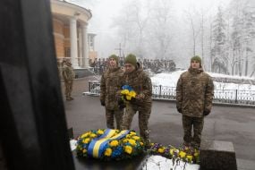 Laying flowers at the memorial cross to the Heroes of Krut
