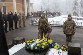 Laying flowers at the memorial cross to the Heroes of Krut