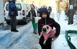 Residents carry out surviving items from the damaged house.
