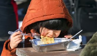 A girl eats pancakes
