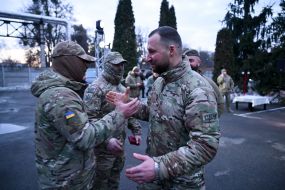 Yevheniy Khmara salutes a serviceman