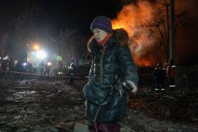 A woman in the ruins of a five-story apartment building hit by a Russian missile in the Kyivsky district of Kharkiv
