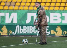 A soldier makes a symbolic kick at the ball