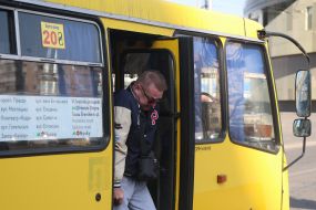 A man gets off a minibus