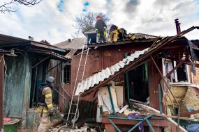 Rescuers work at the site of a strike drone hit in a private sector in Kharkiv
