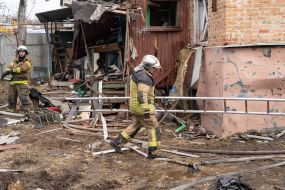 Rescuers work at the site of a strike drone hit in a private sector in Kharkiv