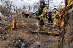 Rescuers work at the site of a strike drone hit in a private sector in Kharkiv