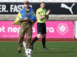 The soldier made a symbolic kick at the ball