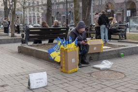 A woman sells Ukrainian flags.