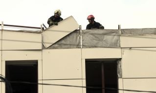 Rescuers on the roof of a hotel damaged by a missile strike.