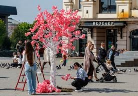Volunteers create the "Sakura Wishing Tree" installation.