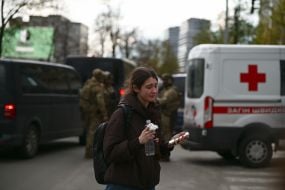 Emotionally depressed young woman near the house where the terrorist lived and set fire to the apartment