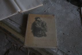 A book about Lenin on the library floor in a dilapidated school building in Pripyat