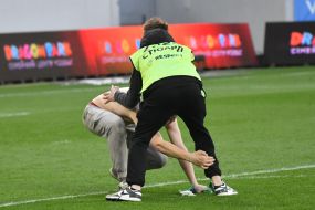 The Stewarts catch a fan who ran onto the field