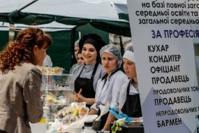 A visitor buys products from students at a vocational education institution