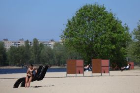 People relax on the beach in Natalka Park in Kyiv