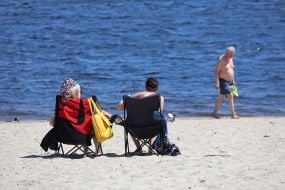 People relax on the beach in Natalka Park in Kyiv