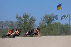 People relax on the beach in Natalka Park in Kyiv