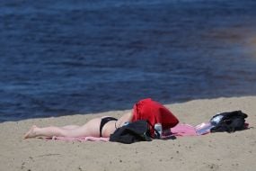 People relax on the beach in Natalka Park in Kyiv