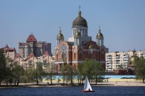 Benches and chairs on the beach in Natalka Park against the backdrop of the Holy Intercession Cathedral