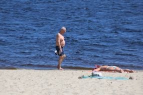 People relax on the beach in Natalka Park in Kyiv