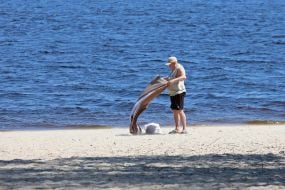 People relax on the beach in Natalka Park in Kyiv