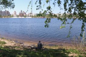 People relax on the beach in Natalka Park in Kyiv