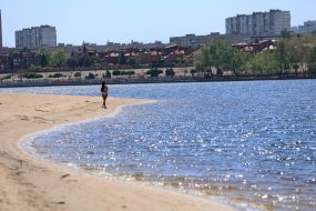 People relax on the beach in Natalka Park in Kyiv
