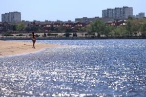 People relax on the beach in Natalka Park in Kyiv