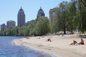 People relax on the beach in Natalka Park in Kyiv