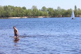 People relax on the beach in Natalka Park in Kyiv