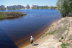 People relax on the beach in Natalka Park in Kyiv