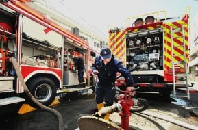 Rescuers near fire trucks