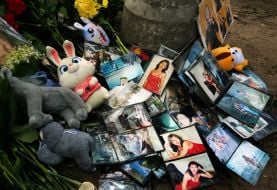 Flowers, photos and toys near the house in the Darnytskyi district of Kyiv that was hit by a Russian missile