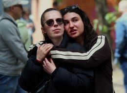 People near the house in the Darnytskyi district of Kyiv that was hit by a Russian missile