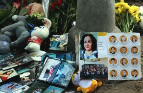 Flowers, photos and toys near the house in the Darnytskyi district of Kyiv that was hit by a Russian missile