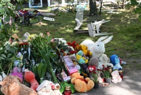 Flowers, photos and toys near the house in the Darnytskyi district of Kyiv that was hit by a Russian missile
