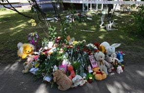 Flowers, photos and toys near the house in the Darnytskyi district of Kyiv that was hit by a Russian missile
